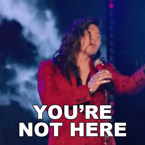A Woman In A Red Suit Singing Into A Microphone With The Words You 'Re Not Here Above Her GIF