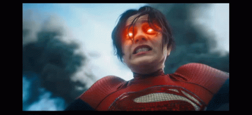 A Woman In A Red Superhero Costume Has Red Eyes GIF