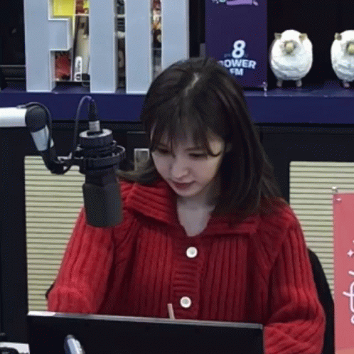 Woman In Red Sweater Sitting At Microphone GIF