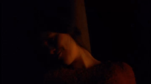 A Woman In A Red Sweater Is Smiling With The Words Digging Holes For Posts Below Her GIF