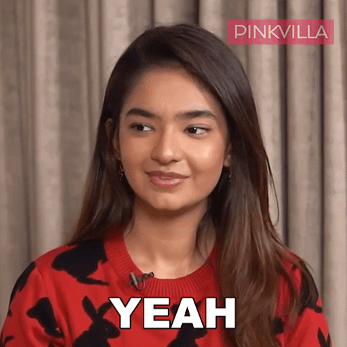 A Woman In A Red Sweater Says Yeah In Front Of A Pink Villa Logo GIF