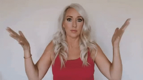 A Woman In A Red Tank Top Is Standing With Her Arms Outstretched . GIF