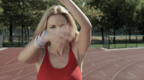 A Woman In A Red Tank Top Is Throwing A Basketball GIF