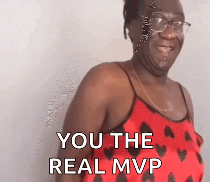 A Woman In A Red Tank Top With Hearts On It Is Smiling And Says `` You The Real Mvp '' . GIF