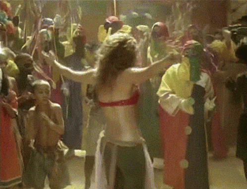 A Woman In A Red Top Is Dancing In A Crowd GIF