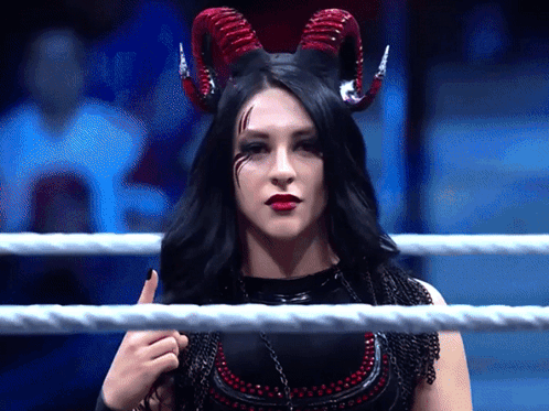 A Woman In A Ring With Horns On Her Head GIF