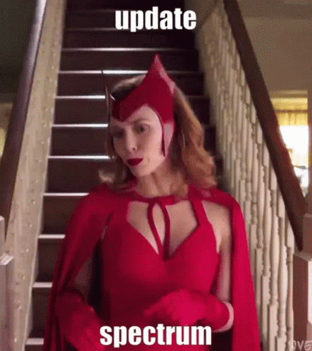 A Woman In A Scarlet Witch Costume Is Standing On Stairs GIF
