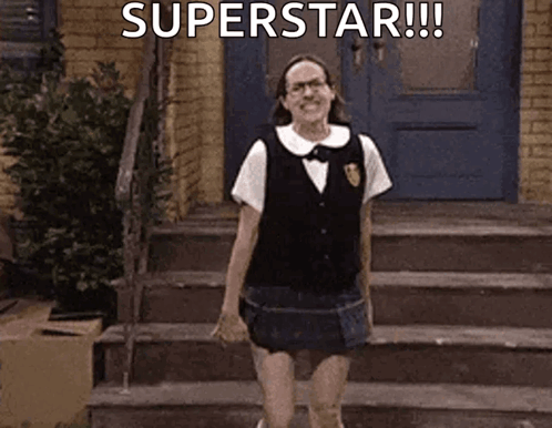 A Woman In A School Uniform Is Standing On A Set Of Stairs With The Words `` Superstar '' Written Above Her . GIF