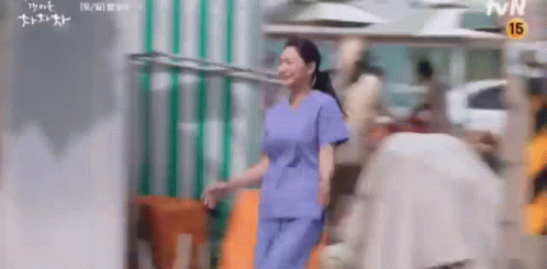 A Woman In A Scrub Is Jumping A Rope In A Blurry Photo . GIF