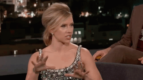 A Woman In A Sequined Dress Is Making A Funny Face GIF