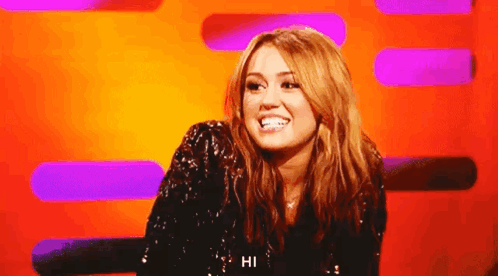 A Woman In A Sequined Top Says Hi GIF
