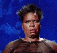 A Woman In A Sheer Top Is Making A Funny Face Against A Blue Background . GIF