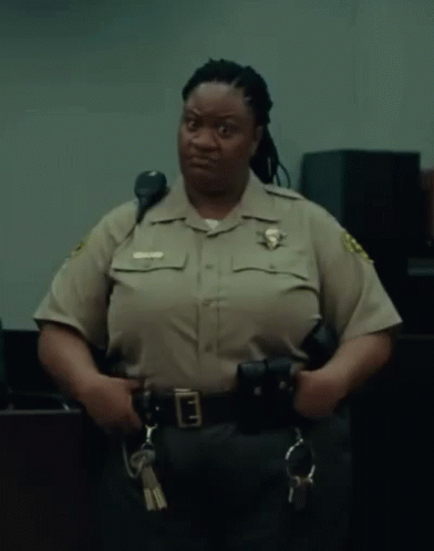 A Woman In A Sheriff 'S Uniform Holds A Pair Of Handcuffs And A Pair Of Keys GIF