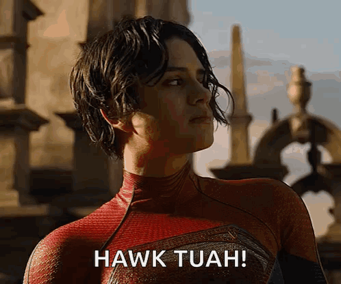 A Woman In A Spiderman Costume Says " Hawk Tuah " GIF