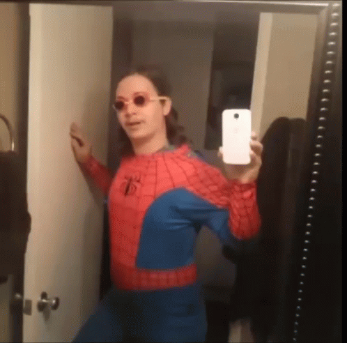 A Woman In A Spiderman Costume Takes A Selfie GIF