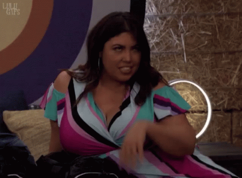 A Woman In A Striped Dress Is Sitting On A Couch With The Words Lulu Clips Written On The Bottom GIF