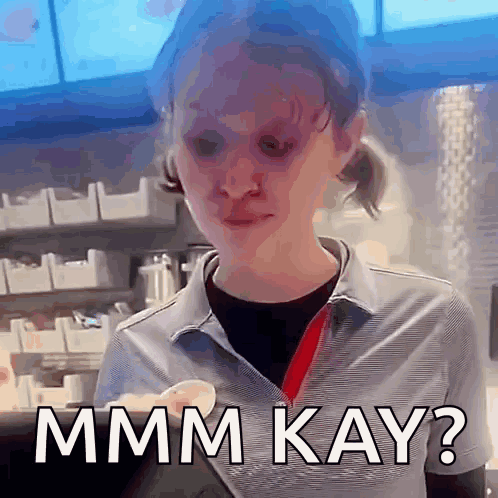 A Woman In A Striped Shirt Is Making A Funny Face And Says Mmmm Kay ? GIF