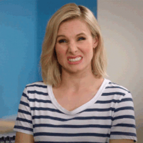 A Woman In A Striped Shirt Is Making A Funny Face . GIF