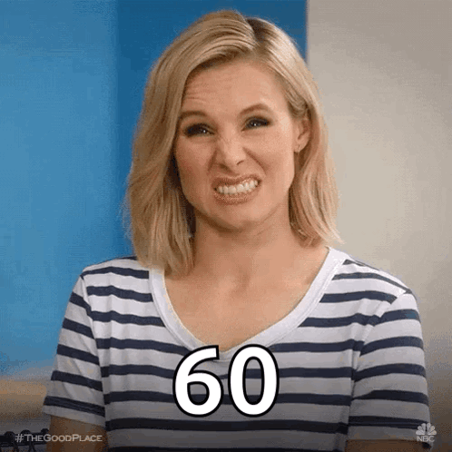 A Woman In A Striped Shirt Is Making A Funny Face With The Number 60 Written On Her Face . GIF