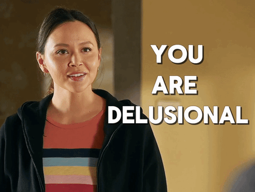 A Woman In A Striped Shirt Is Standing In Front Of A Sign That Says " You Are Delusional " GIF