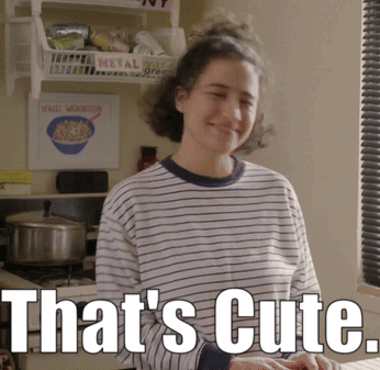 A Woman In A Striped Shirt Says That 'S Cute In White Letters GIF