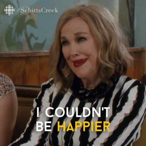 A Woman In A Striped Shirt With The Words I Couldn 'T Be Happier GIF