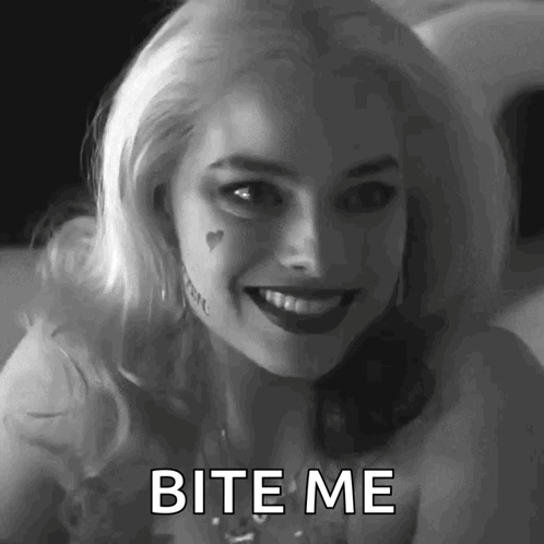 A Woman In A Suicide Squad Costume Is Smiling And Says Bite Me . GIF
