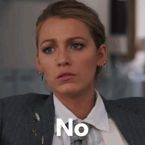 A Woman In A Suit And Tie Has The Word No Written On Her Face GIF