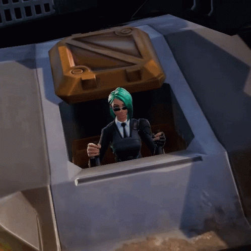 A Woman In A Suit And Tie Is Standing In A Container GIF