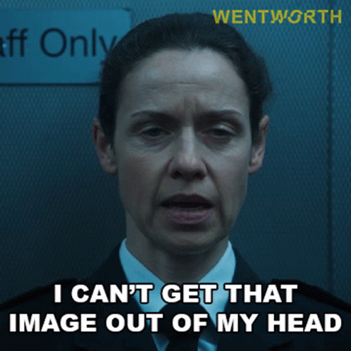 A Woman In A Suit And Tie Is Standing In Front Of A Sign That Says Staff Only GIF
