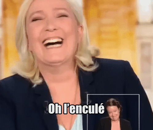 A Woman In A Suit Is Laughing With The Words Oh L'encule Below Her GIF
