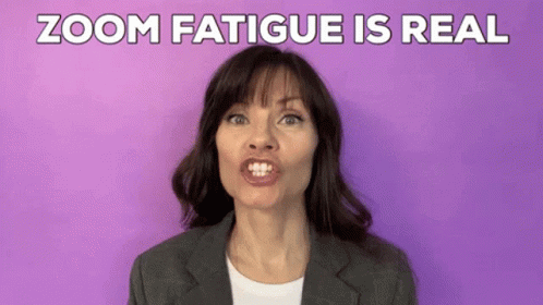 A Woman In A Suit Is Making A Funny Face In Front Of A Purple Background And The Words Zoom Fatigue Is Real . GIF
