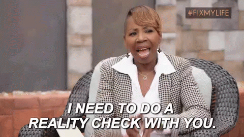 A Woman In A Suit Is Sitting In A Chair And Saying `` I Need To Do A Reality Check With You '' . GIF