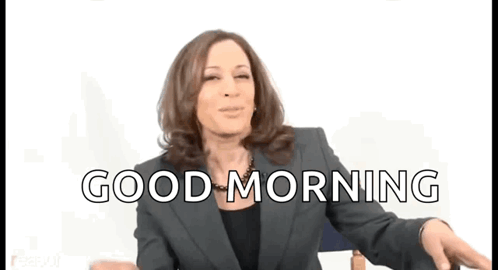 A Woman In A Suit Says Good Morning While Dancing GIF