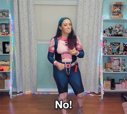 A Woman In A Superhero Costume Says No While Dancing GIF
