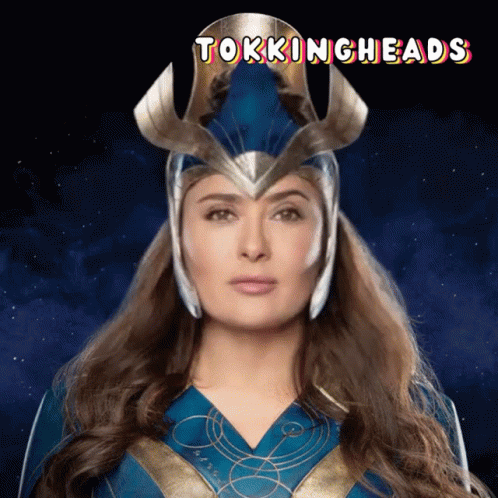 A Woman In A Superhero Costume With The Words Talkingheads On The Bottom GIF