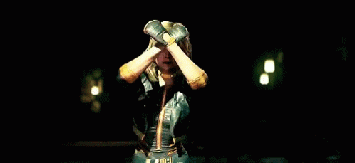 A Woman In A Superhero Outfit Is Screaming With Her Mouth Open GIF