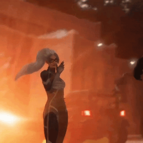 a woman in a superhero outfit is standing in front of a fire