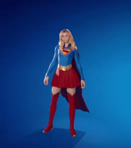 A Woman In A Superman Costume Is Dancing With Her Fist In The Air GIF