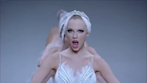 A Woman In A Swan Dress Is Surrounded By Other Swans . GIF