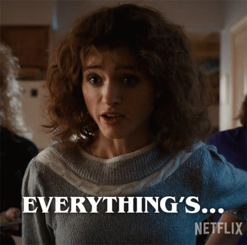 A Woman In A Sweater Says " Everything 'S " On A Netflix Poster GIF