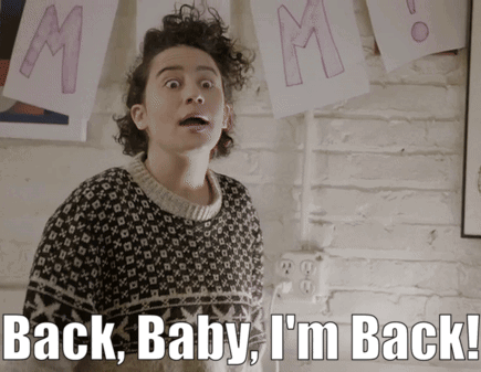 A Woman In A Sweater With The Words Back Baby I 'M Back GIF