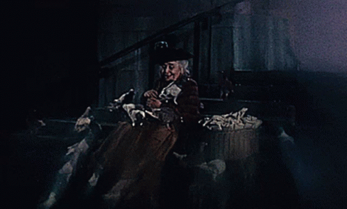 A Woman In A Top Hat Is Holding A Ghost GIF