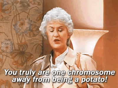 A Woman In A Trench Coat Is Saying `` You Truly Are One Chromosome Away From Being A Potato! '' GIF