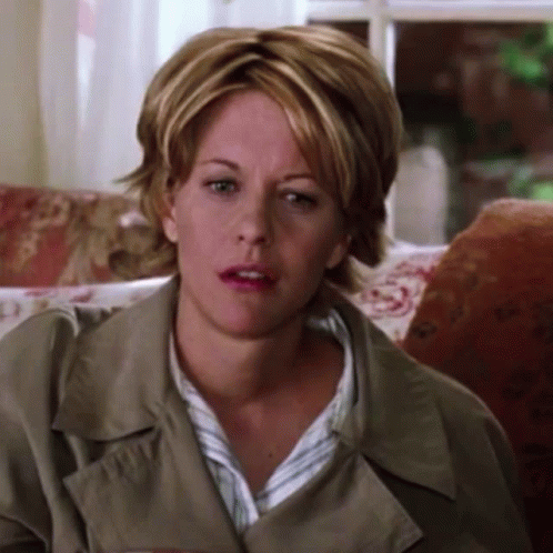 Woman In Trench Coat Making Funny Face GIF
