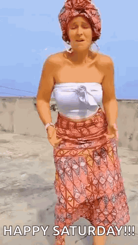 A Woman In A Turban Is Dancing On A Rooftop . GIF