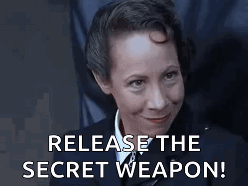 a woman in a uniform is smiling and says `` release the secret weapon ! ''