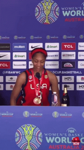 A Woman In A Usa Jersey Stands In Front Of A Sign That Says Women 'S World Cup Australia 2 GIF