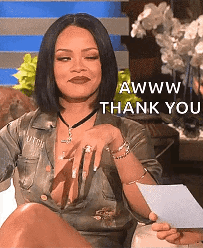 A Woman In A Very Revealing Shirt Is Holding A Piece Of Paper That Says Awww Thank You GIF