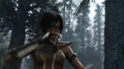 A Woman In A Video Game Holding A Sword In A Forest GIF